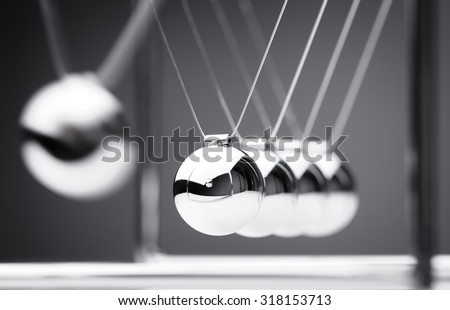 Newton's cradle physics concept for action and reaction or cause and effect