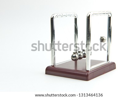 Newton's pendulum close-up on white background.