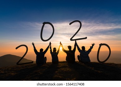 Newyear 2020 Concept Silhouette Of Young Friend Jumping And Hand Shake For Celebrate New Year Party.