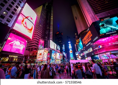 NewYork City, NY, USA- August 03, 2016. Time Square by night with crowds of tourists and LED signs lighting up the place.