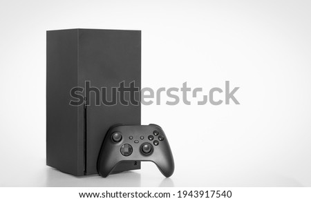 Next Generation game console and controller on white background.