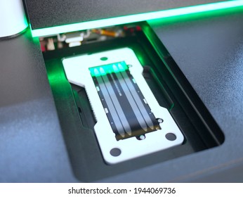next generation sequencing flow cell in DNA sequencer. genetic engineering, genetic modification, designer baby and cloning concept. cancer screening and medical technology and therapy.