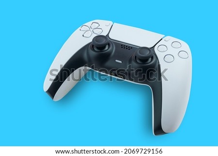 Next Generation white game controller isolated on blue background. Top view.