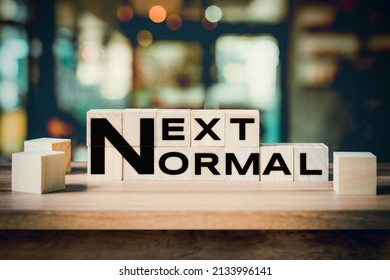 Next Normal Word On Wooden Cube Block On Wood Table Background.