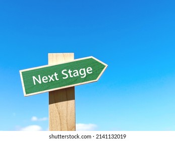 Next Stage Text Green Signpost In Blue Sky And Right Space