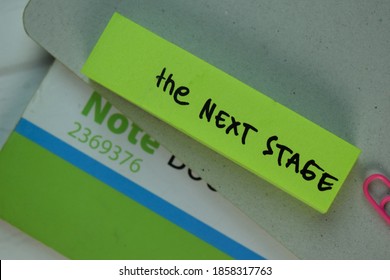 The Next Stage Write On Sticky Note Isolated On Wooden Table.