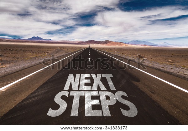 Next Steps written on desert\
road