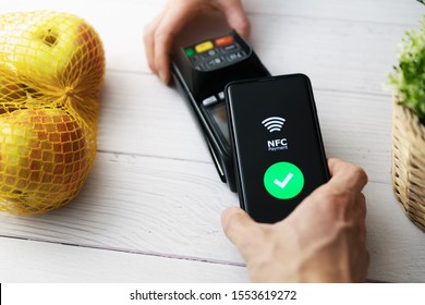 Nfc Contactless Payment With Phone At Groceries Store