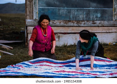 Ngawa Tibetan and Qiang Autonomous Prefecture，China-September,2019: Two women are working by the front door of a house