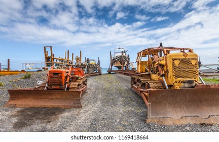 at Ngawi Harbour, New Zealand, north Island, the local beached fishing fleet is launched to sea by old, rusty bulldozers