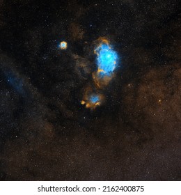 NGC 6559 Nebula imaged through Telescope Live's remote robotic telescopes in narrowband filters (SHO), blue and yellow nebulosity in hubble palette of a big space object