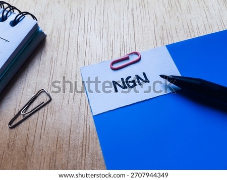 NGN writting on table background. 