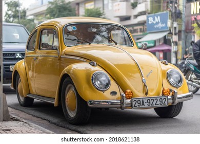 Nha Trang, Khanh Hoa Province, Vietnam - January 9, 2019: An old yellow Volkswagen beetle stands in a parking space near the sidewalk. Excellent condition
