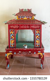 Nha Trang, Vietnam - March 11, 2019: Dinh Phu Vinh Community Center And Celebration Hall. Beautifully Carved And Painted Red, Yellow And Blue Wooden Cage On Legs Looks Is Empty.