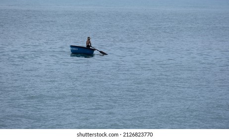 NHATRANG CITY, VIETNAM – FEBRUARY 16, 2022: A Man Rowing A Boat Alone In The Sea.