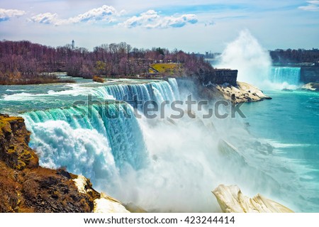 Niagara Falls from the American side in spring. A view from Niagara State Park on American Falls, Bridal Veil Falls, Goat Island and Horseshoe falls on the background.