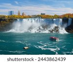 Niagara Falls. A pleasure boat with people near the huge famous waterfall. View from the Canadian side. Nature scenery. Photo for advertising.