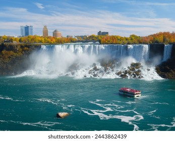 Niagara Falls. A pleasure boat with people near the huge famous waterfall. View from the Canadian side. Nature scenery. Photo for advertising. - Powered by Shutterstock