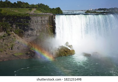 Niagara Falls in summer along with a rainbow.