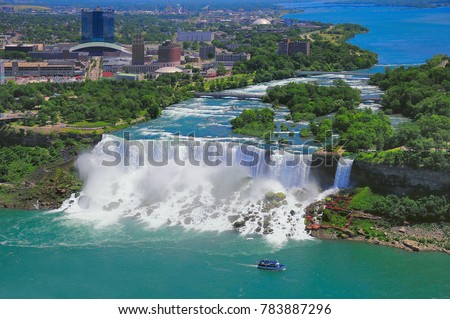 Niagara Falls from the US side, Bride Veil Falls. Boat with tourists moves along Bride Veil Falls.