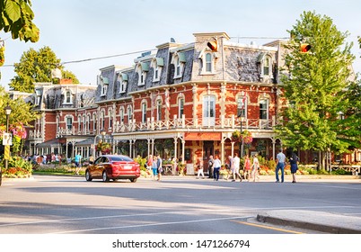 NIAGARA ON THE LAKE, CANADA - AUGUST 3, 2019: Prince of Wales Hotel with horse carriage in Niagara On The Lake. Built in 1864, this hotel with 100 rooms is a landmark hotel, Ontario, Canada
