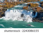 Niagara River American Falls in autumn foliage season. Niagara City Cruise Boat Tour. Niagara Falls City, Ontario, Canada.