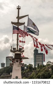 Niagra Falls Canada 06.09.2017 Flags On The Famous Falls Boat Tour Experience In Front Of The Niagara Skyline