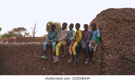 Niamey, Niger 12, 2021: African Children Sitting On The Wall