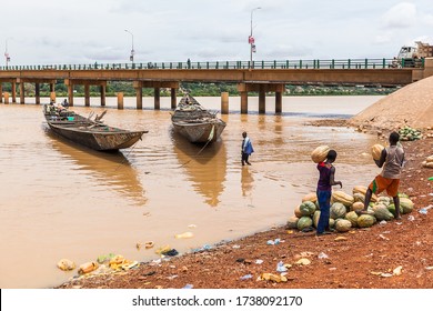 Niamey, Niger - September 2013: Wooden boats on Niger River muddy water 