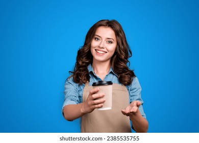 Nice adorable positive cheerful sweet winsome lovely attractive girl, barista with wavy hair in casual denim shirt, offering, handling you paper cup, rest, pause, relax, isolated over grey background - Powered by Shutterstock