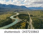 Nice aerial view of the Icefield Parkway next to the Athabasca River that makes a nice S shape. On a sunny day with fall clouds in Jasper National Park.