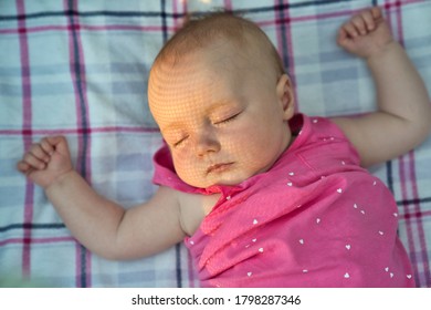 A Nice Baby Sleeping Outside On The Bed