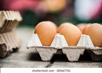 Nice big rural fresh eggs in cardboard egg box holder with colorful blurred background