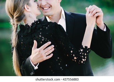 A Nice Black Dressed Couple Waltzing And Laughing,green Background