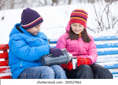 Nice Boy And Girl Sharing Tea. Boy Pouring Tea Into Steel Cup