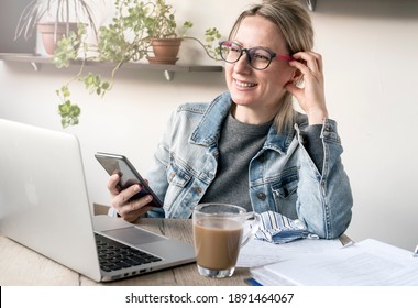Nice business woman in a cozy workplace works with pleasure - Shutterstock ID 1891464067