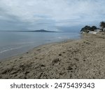 A nice calm morning from the shore of millford beach in auckland.