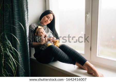 Similar – Image, Stock Photo Mother giving bottle to her newborn