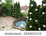 Nice central courtyard with fountain and flagstone patio and evergreen trees. Wedding decorated with white balloons