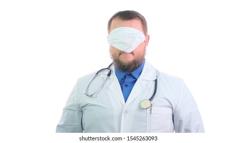 Nice Chubby Dumb Doctor With A Beard In A White Coat On A White Isolated Background Smiles And Not Wearing A Mask Correctly