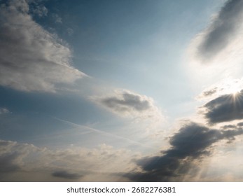 Nice cloudy sky with sun rays. Calm and peaceful mood and feel. Nature background for design.