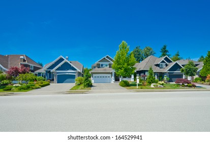 Nice and comfortable neighborhood. Some homes on the empty street in the suburbs of the North America. Canada. - Shutterstock ID 164529941