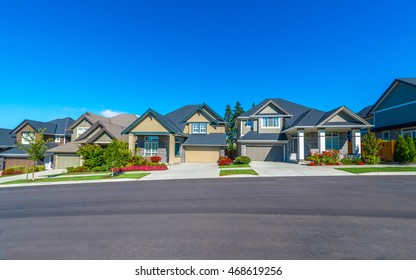 Nice and comfortable neighborhood. Some homes on the empty street in the suburbs of the North America. Canada.