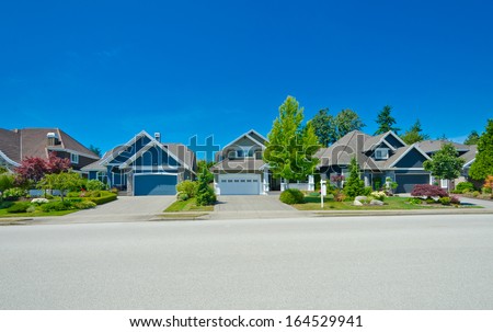 Nice and comfortable neighborhood. Some homes on the empty street in the suburbs of the North America. Canada.
