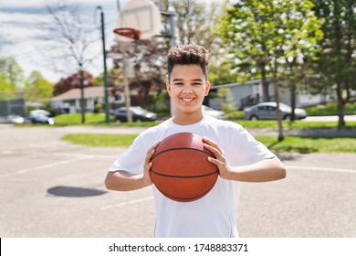 A nice and cool Afro american players playing basketball outdoors - Powered by Shutterstock