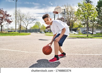 A nice and cool Afro american players playing basketball outdoors