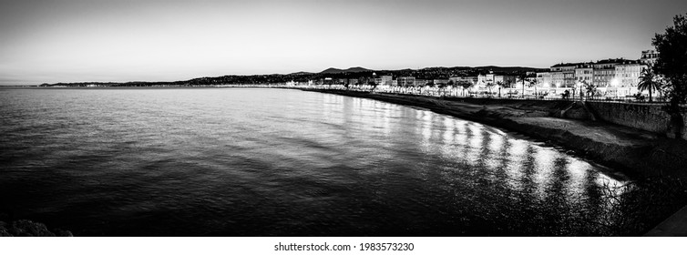 Nice, Cote D'Azur, France - March 2019: Panoramic Twilight View Of The French Mediterranean Riviera Coastline Of Promenade Des Angles In Black And White