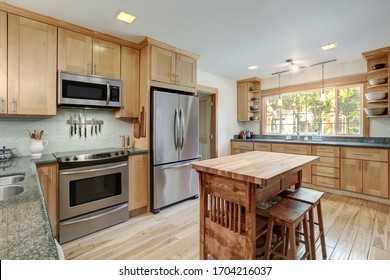 Nice Country Home Wood Kitchen With Wooden Island And Ligth Green Tiles.