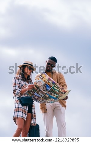 Nice couple is looking on the map to find the place they want to visit