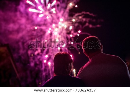 Nice couple watching at night the incredible fireworks in Barcelona, Spain